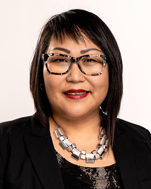 Woman with dark short hair and glasses